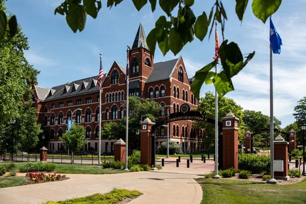 DuBourg Hall at Saint Louis University, with a campus gateway and sidewalk